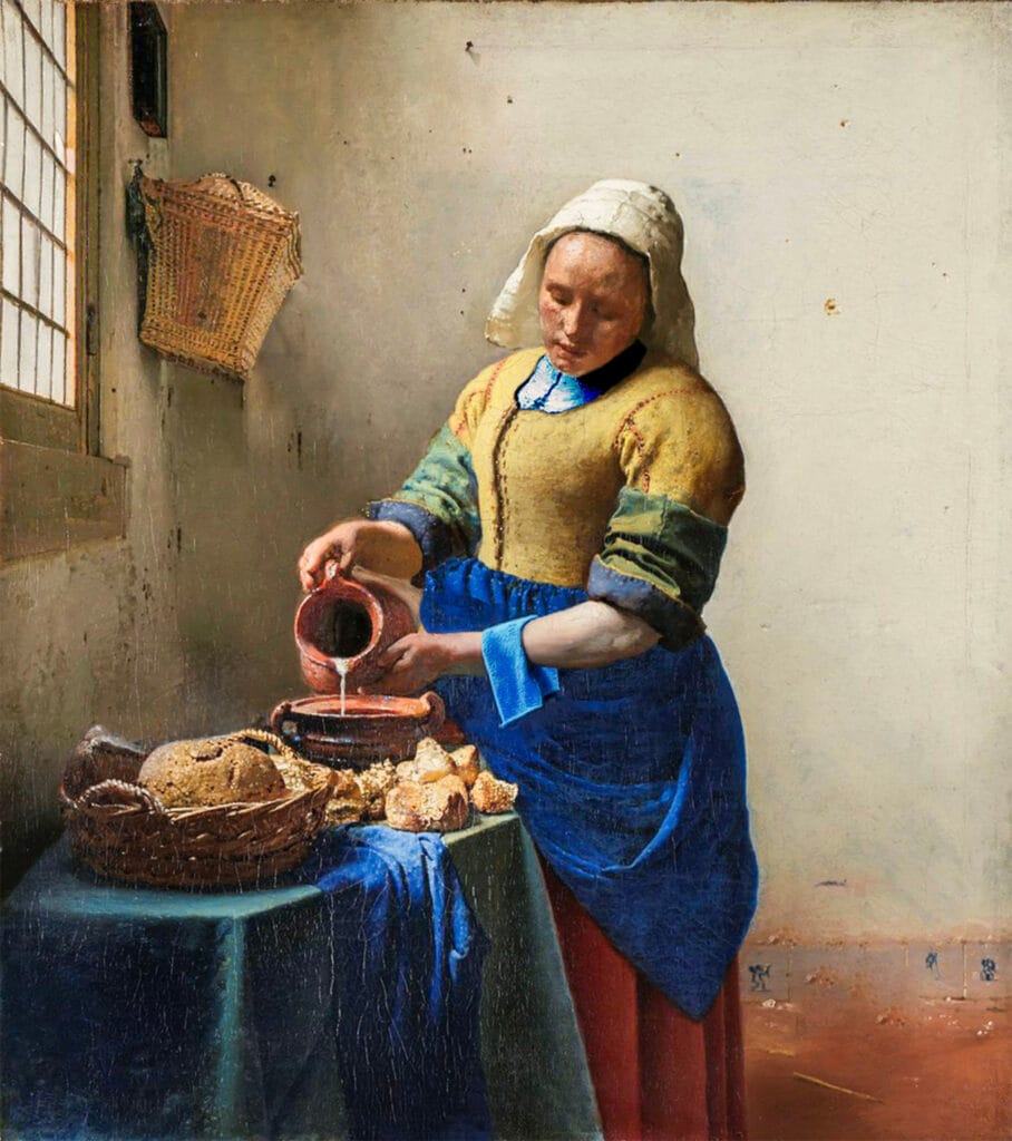 Puzzles Book Experience: Hardcover Feel, Digital Ease 3 A woman in traditional Dutch attire pours milk into a bowl near a sunlit window, surrounded by rustic kitchen items, bread, and a blue cloth in a simple, white-walled room.